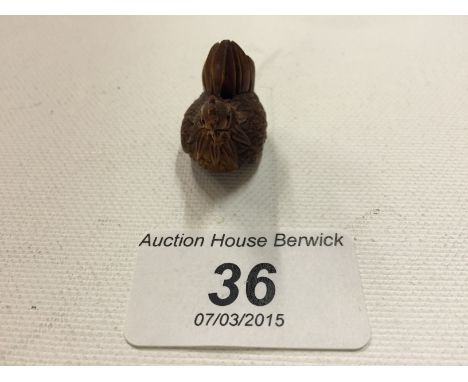 A tiny carved wooden netsuke of a chicken 20 mm.