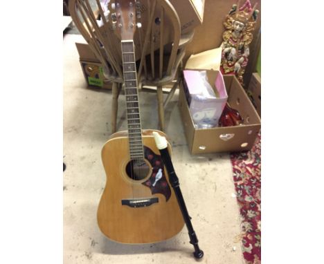 A steel sttring Kent guitar and a recorder.