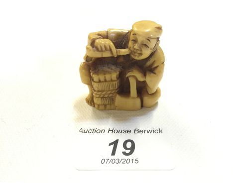 An netsuke of a woodsman smoking a pipe 40 mm.