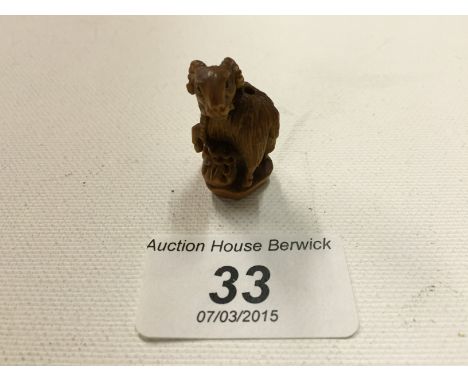A small carved wooden netsuke of a goat 29 mm.