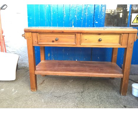 A large pine cutting block with marble top and two way drawers with a shelf below and towel rails to either side.
