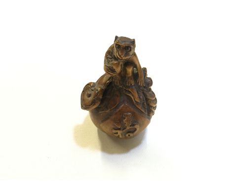 A small carving of a monkey on a giant peach could be classed as a netsuke as has gaps for cord 70 mm.