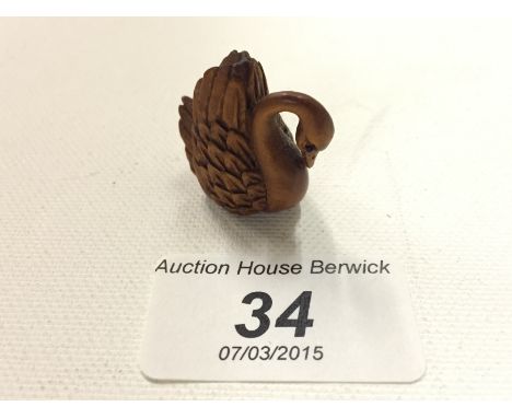 A carved woodensmall netsuke of a swan. 25 mm