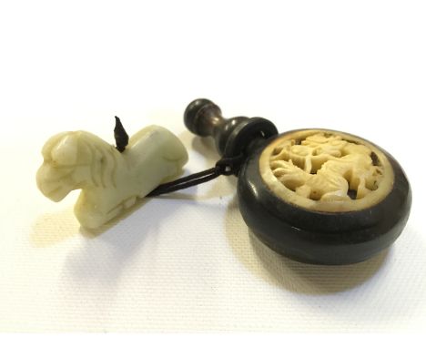 A small wooden Japanese scent bottle with dragon insert and a jade lion.