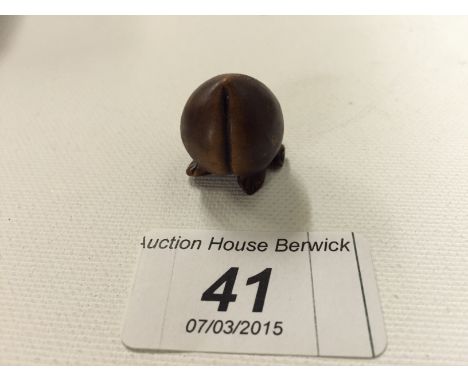 A small carved wooden netsuke of a peach 20mm.