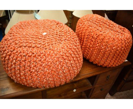 A pair of vintage knitted wool pouffe stools, in orange