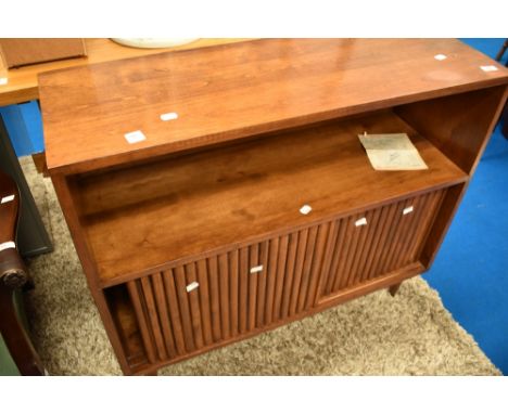 A vintage sapele and walnut shelf/cocktail cabinet having open shelf and concealed cupboard behind sliding doors, on tapered 