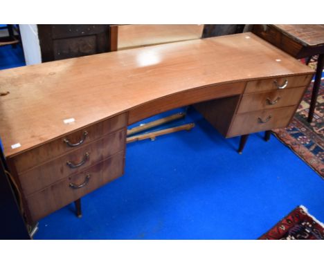 A vintage teak dressing table of curved form, width approx. 163cm, mirrors have been removed but are present