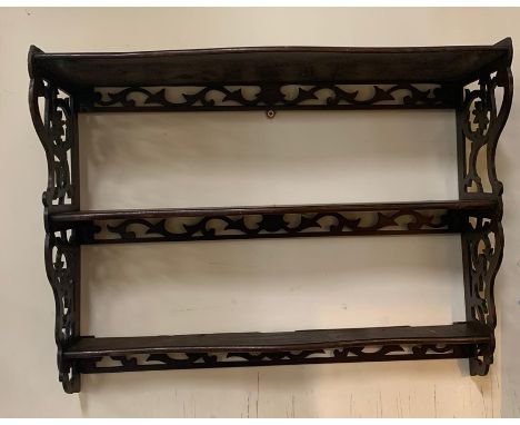 A mahogany three tier hanging wall shelf with pierced scroll work to side (H46cm W59cm D18cm)