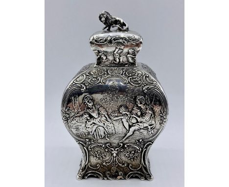 A silver tea caddy with repousse design and lion finial by Samuel Boyce, hallmarked for Chester 1903 (H15cm x W9cm x D7cm)