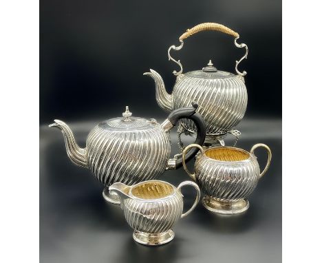 A Victorian silver teapot, teapot on stand, sugar bowl and milk jug by Charles Stuart Harris, hallmarked for London 1883 (134