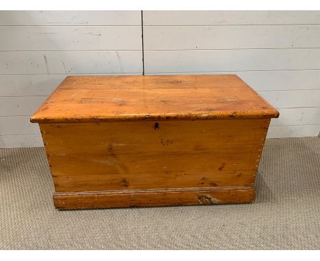 A pine trunk with brass handles (H49cm W95cm D50cm)