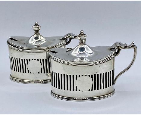 A pair of silver salts with blue glass liners by Haseler Brothers (Edward John Haseler &amp; Noble Haseler), Chester 1905.