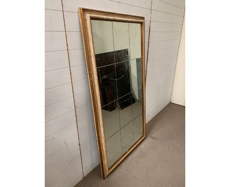 A twelve panel glass wall mirror (91cm x 167cm)