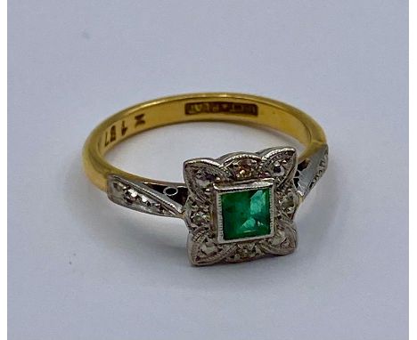 An 18ct gold and platinum emerald and diamond ring Size K