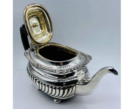 A substantial silver teapot, (Total weight 695g) on four feet, by George Nathan &amp; Ridley Hayes and hallmarked for 1903.