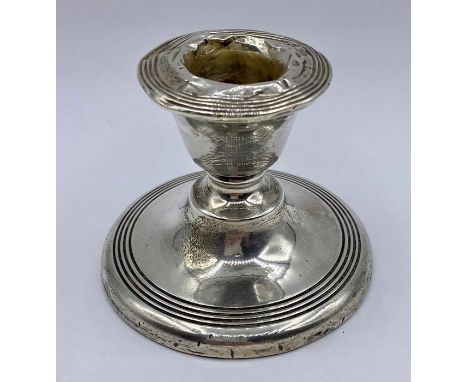 A Silver squat candlestick by James Deakin &amp; Sons Chester 1913, 6 cm high.