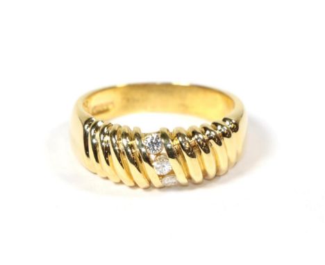 An 18 carat gold diamond three stone ring, total estimate diamond weight 0.15 carat approximately, finger size M.  Gross weig