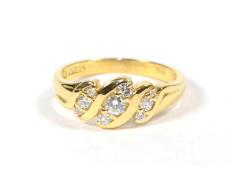 An 18 carat gold diamond twist ring, finger size P.  Gross weight 4.47 grams. 