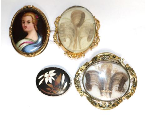 Two oval mourning brooches; a sliver mounted hardstone brooch, and an oval porcelain portrait brooch (4) .  All unmarked. Gro