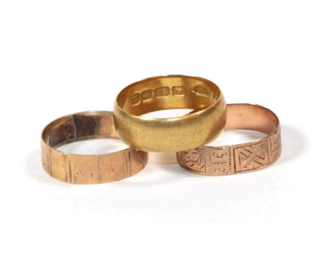 A 22 carat gold band ring, finger size K1/2; and two 9 carat gold patterned band rings, finger sizes K and L (3).  22 carat g