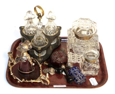 A brass and ebonised wood three piece condiment stand, two glass inkwells, two cut glass scent bottles, two desk seals, a thr