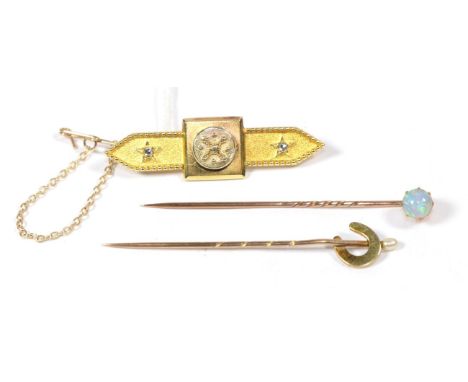 An opal stick pin, unmarked, cased by C Warner; a seed pearl horseshoe stick pin, unmarked, cased; and a rose cut diamond set