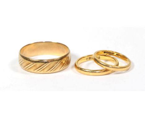 A 9 carat gold band ring, finger size Z; a 22 carat gold band ring, finger size J; and a ring stamped '22CT', finger size N1/