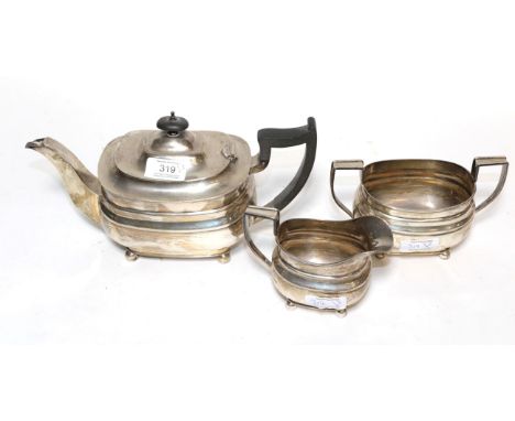 A George VI three-piece silver tea-service, by William Hutton and Sons, Sheffield, 1937, each piece oblong and on ball feet, 