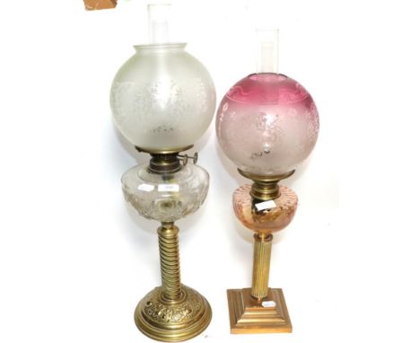 Two oil lamps with glass chimneys and shadesFirst oil lamp with dents to the base. Glass shade with minor chips to the inside