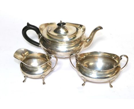 A three-piece George V silver tea-service, by Sydney Hall &amp; Co., Sheffield, 1933, each piece on three pad feet, the teapo