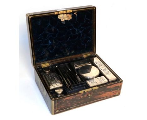 A William IV silver-mounted dressing table-set, the silver mounts London, 1831, contained in a fitted brass-bound coromandel 