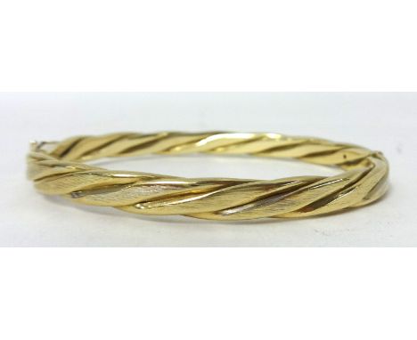 A 9ct gold twist design bangle, weight 18.3g.