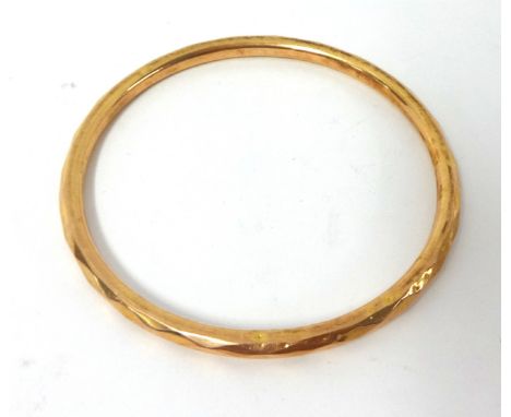 A 9ct rose gold facetted slave Bangle, Birmingham 1925, weight 8 grams.
