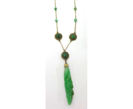 A gold and jade mounted Necklace, the carved floral drop to a trace link chain set with beads and discs, stamped 14, jade unt