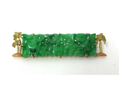 A gold mounted carved jade panel Brooch, with textured palm tree border, jade untested.