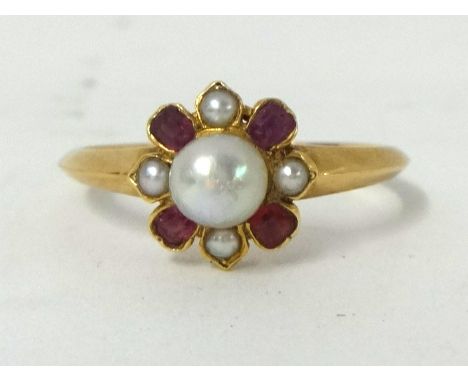 A ruby and pearl cluster Ring, the central bead, untested, bordered by 1/2 pearls and mixed cut rubies, size P.