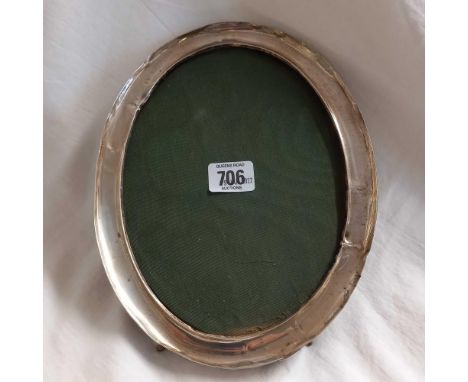 A LARGE OVAL CHINESE SILVER FRAMED PHOTO FRAME ON EASEL SHAPED BACK