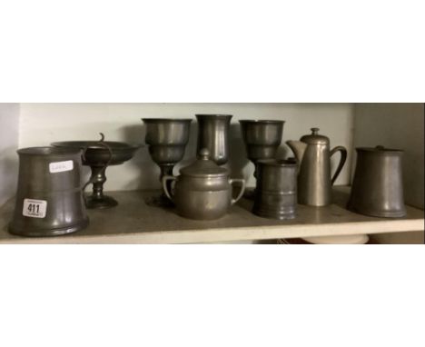 SHELF OF ANTIQUE PEWTER TANKARDS, GOBLETS ETC