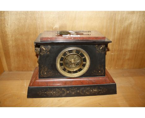 A French black slate and red marble mantel clock with Egyptian hieroglyphics and mask handles, 34.5cm wide and 22cm high 