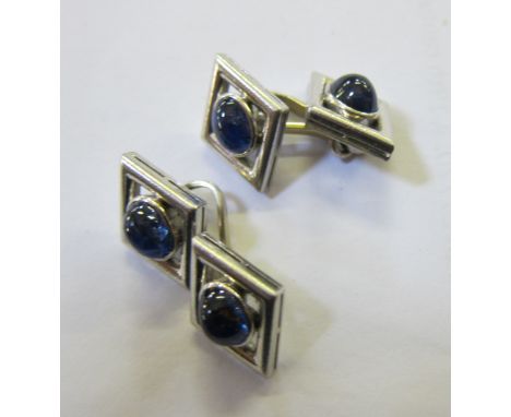 A pair of 18ct white gold and sapphire cufflinks, diamond shaped with oval shaped stones