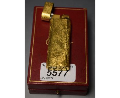 Cartier - an 18ct gold plated cigarette lighter, bark effect, cased