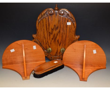 A pair of demi-lune wall brackets, pierced fretwork supports; a carved oak shield shaped hall bracket with hanging hooks, one