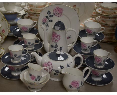 Susie Cooper - a six setting tea and coffee service including coffee pot, teapot, cups, saucers; etc, all decorated with a pi