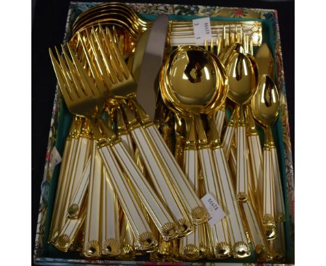 A gold plated and white enamel canteen of cutlery, six place setting, dinner knives and forks, soup spoons, teaspoons, tables