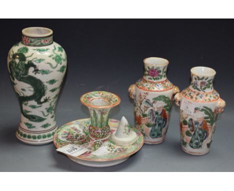 A pair of Chinese miniature Famille Rose vases; a Famille Rose chamber stick; a Famille Verte vase painted with dragons (4)