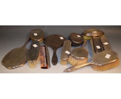 A silver vanity set comprising brushes, comb and mirror, Birmingham 1928; others similar