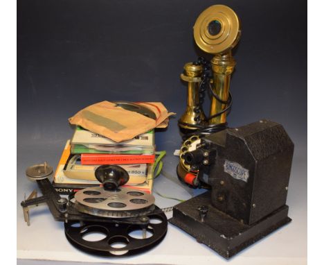 A Bingoscope home projector and film reels; an Astral Telecom brass candlestick telephone