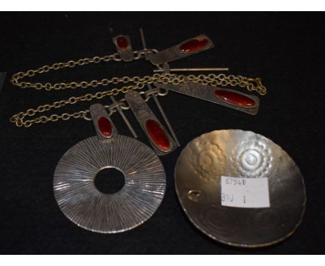 A Scandinavian silver target roundel; a Danish domed shield pendant; a Scandinavian planished and enamel lady's necklace (3)
