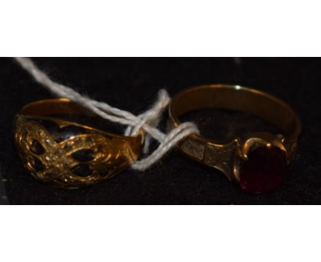 A 19th century mourning ring set with garnet and applied with a plait of hair; another with black enamel and diamonds (2)